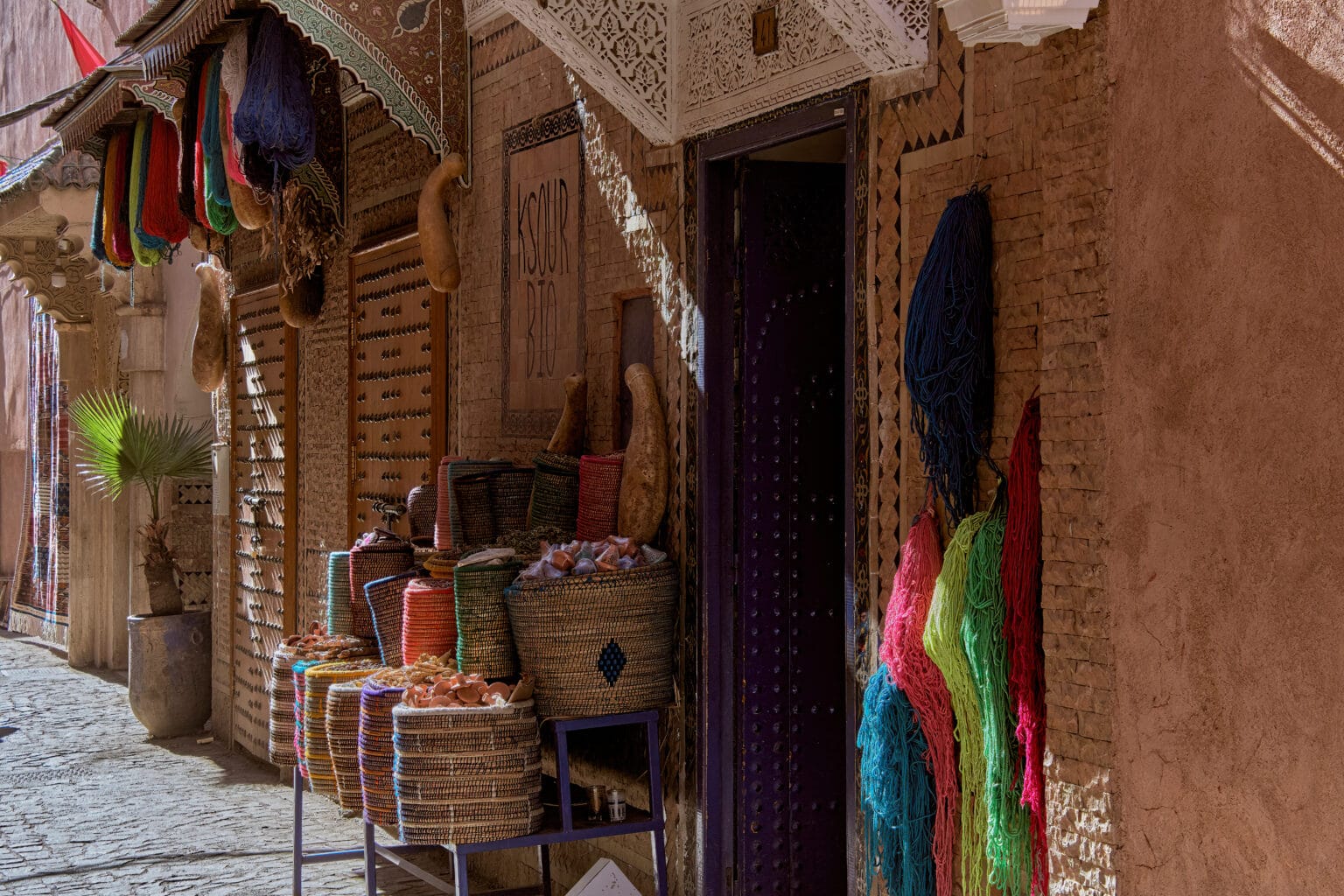 A shop in Marrakech with wooden doors and nail heads of Mozarabic style umbrellas in Morocco